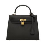 Black handbag with gold hardware on a white background
