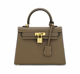 Brown handbag with gold hardware on a white background